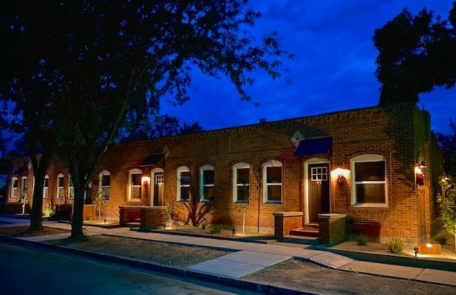 Brick row of casitas at dusk under a deep blue sky