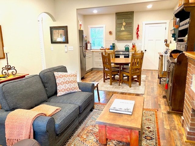 Living room with gray sofa, coffee table and kitchen beyond