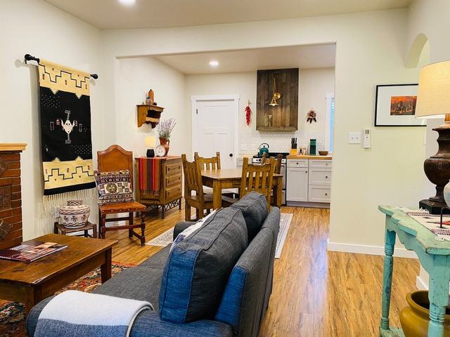 Living room with sofa, dining table and a woven wall hanging
